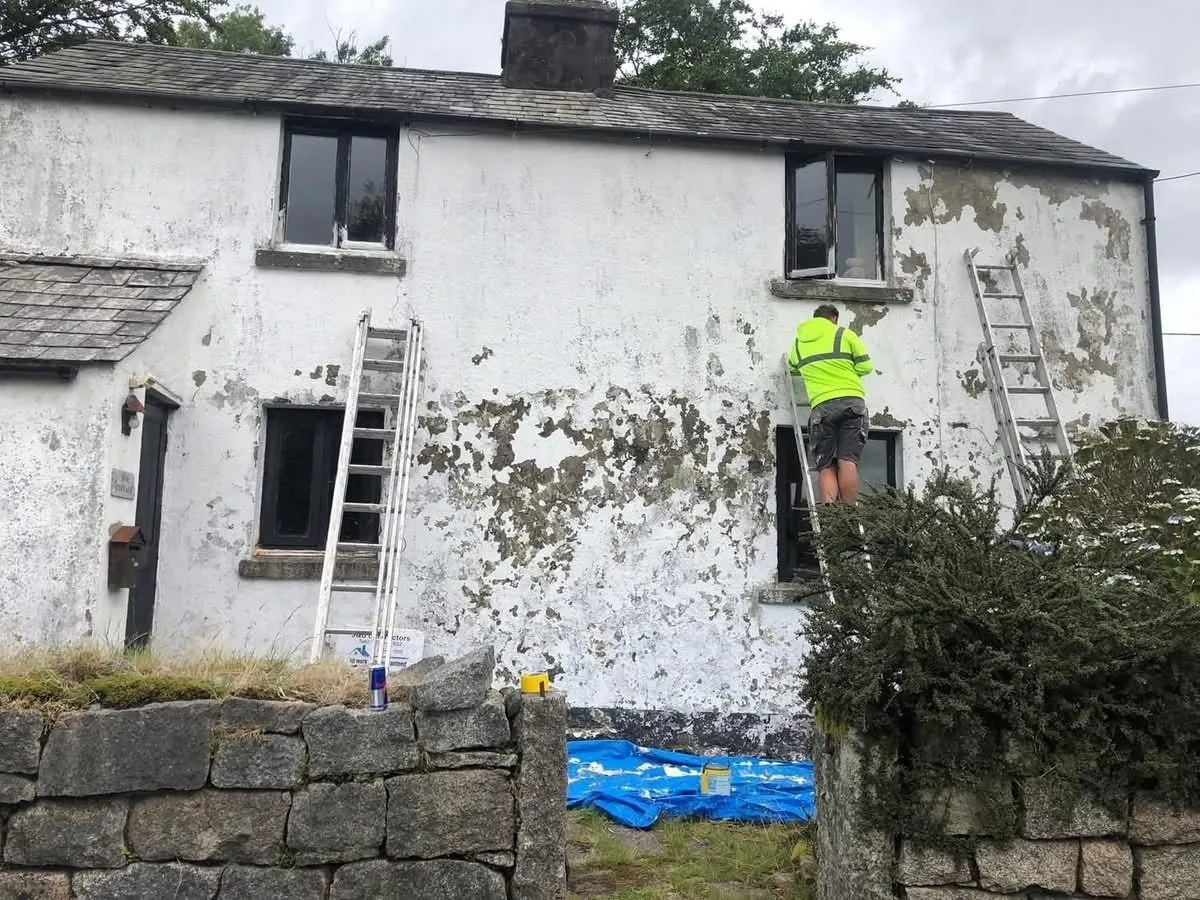 Cottage with blown, flaking render before repair in Teignmouth